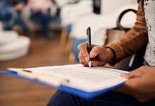 Patient filling out paperwork in lobby