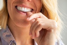 a woman wearing SureSmile clear aligners 