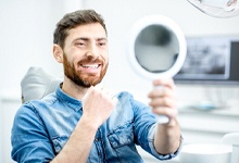 Dental patient admiring the results of his cosmetic dental bonding in Crookston