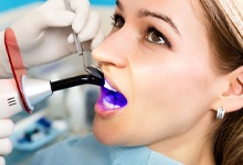 Woman undergoing dental bonding to fill gapped teeth in Crookston