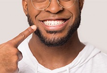 Man pointing to smile after dental bonding