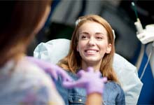 Woman smiling at her emergency dentist in Crookston