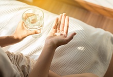 Woman holding a pill