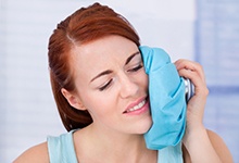 Woman using a cold compress