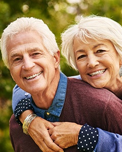 Happy couple with dental implants in Crookston Minnesota