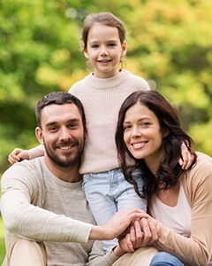 Happy family smiling after visiting the Renu Dental team