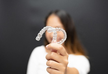 a person holding their Spark clear aligners