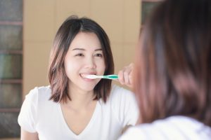 person brushing their teeth